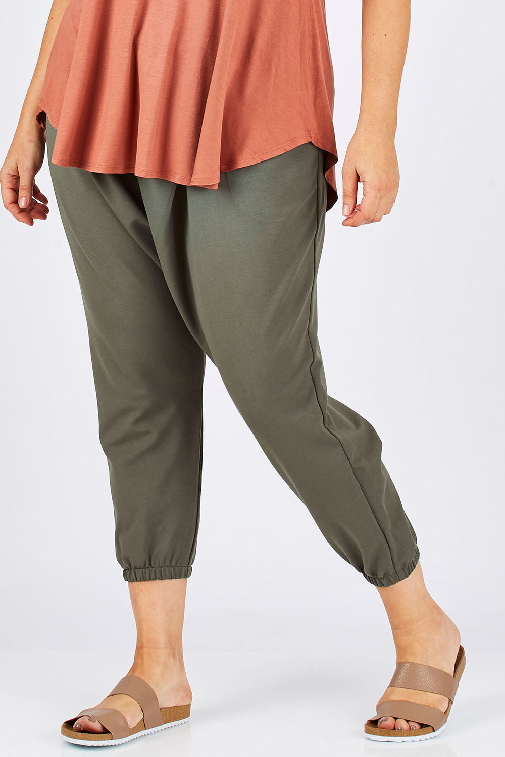 Model Ljubenka wearing size 18 of the Relax With Me Pants in colour Moss (Green), from the front, cropped image