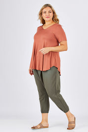 Model Ljubenka wearing size 18 of the Relax With Me Pants in colour Moss (Green), from the front, showing the whole outfit