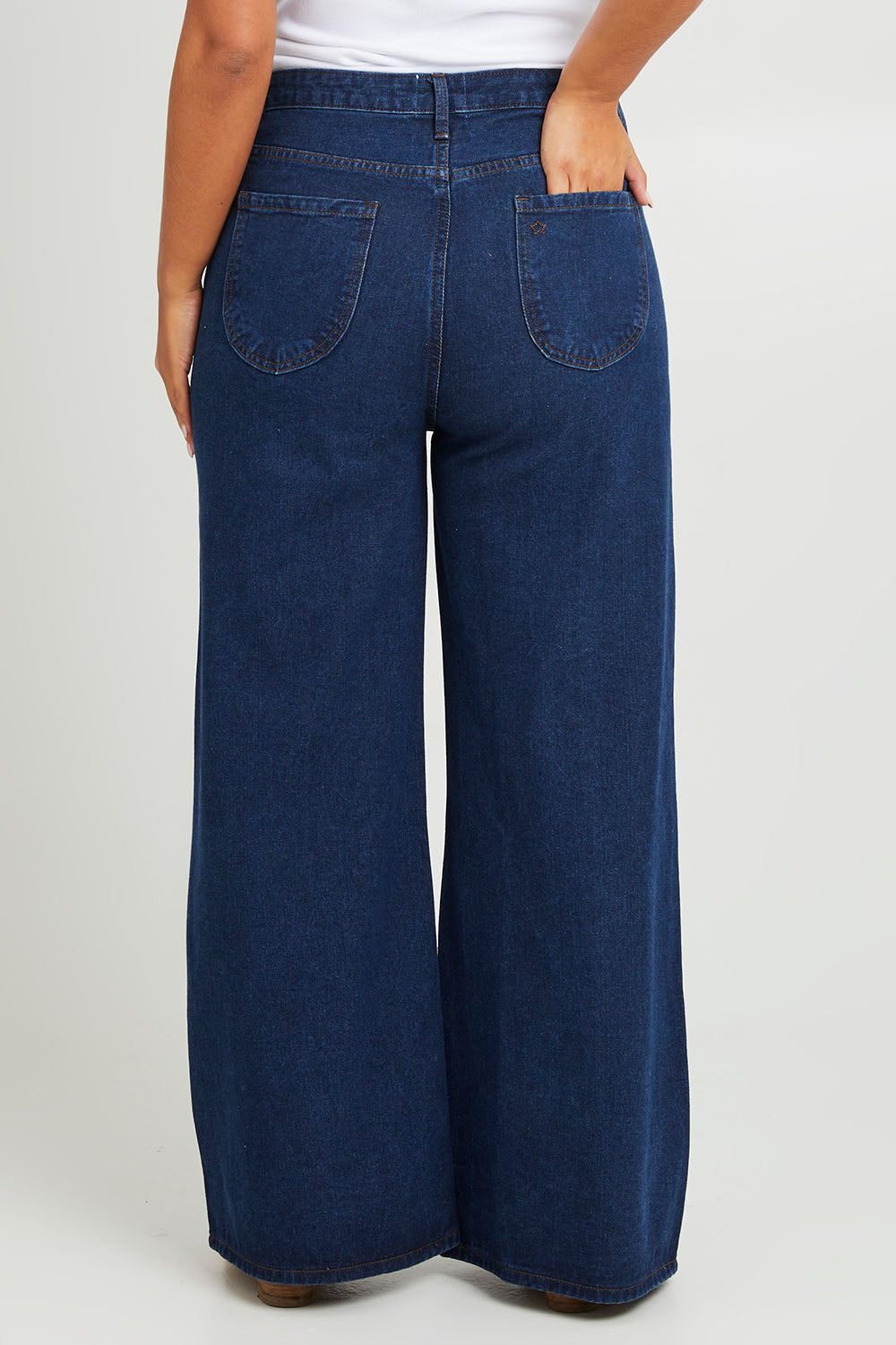 Model Monique wearing size 14 of the Happy Me Wide Leg Jeans in colour Darkdenim (Blue), from the back
