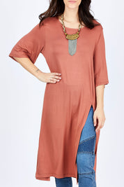 Model Georgia wearing size 10 of the Softly Falling Bamboo Tunic in colour Copper, from the front, cropped image