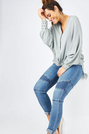 Model Laura wearing size 14 of the Wild One Stitched Jeggings in colour Denim (Blue), from the front, showing the whole outfit