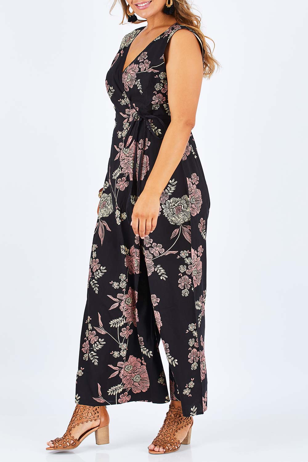Model Palatina wearing size 14 of the Illusion Faux Wrap Jumpsuit in colour Blackfleur (Black), from the front, cropped image