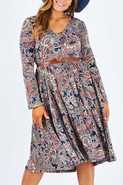 Model Palatina wearing size 14 of the Wind In My Hair Dress in colour Paisley (Red), from the front, cropped image