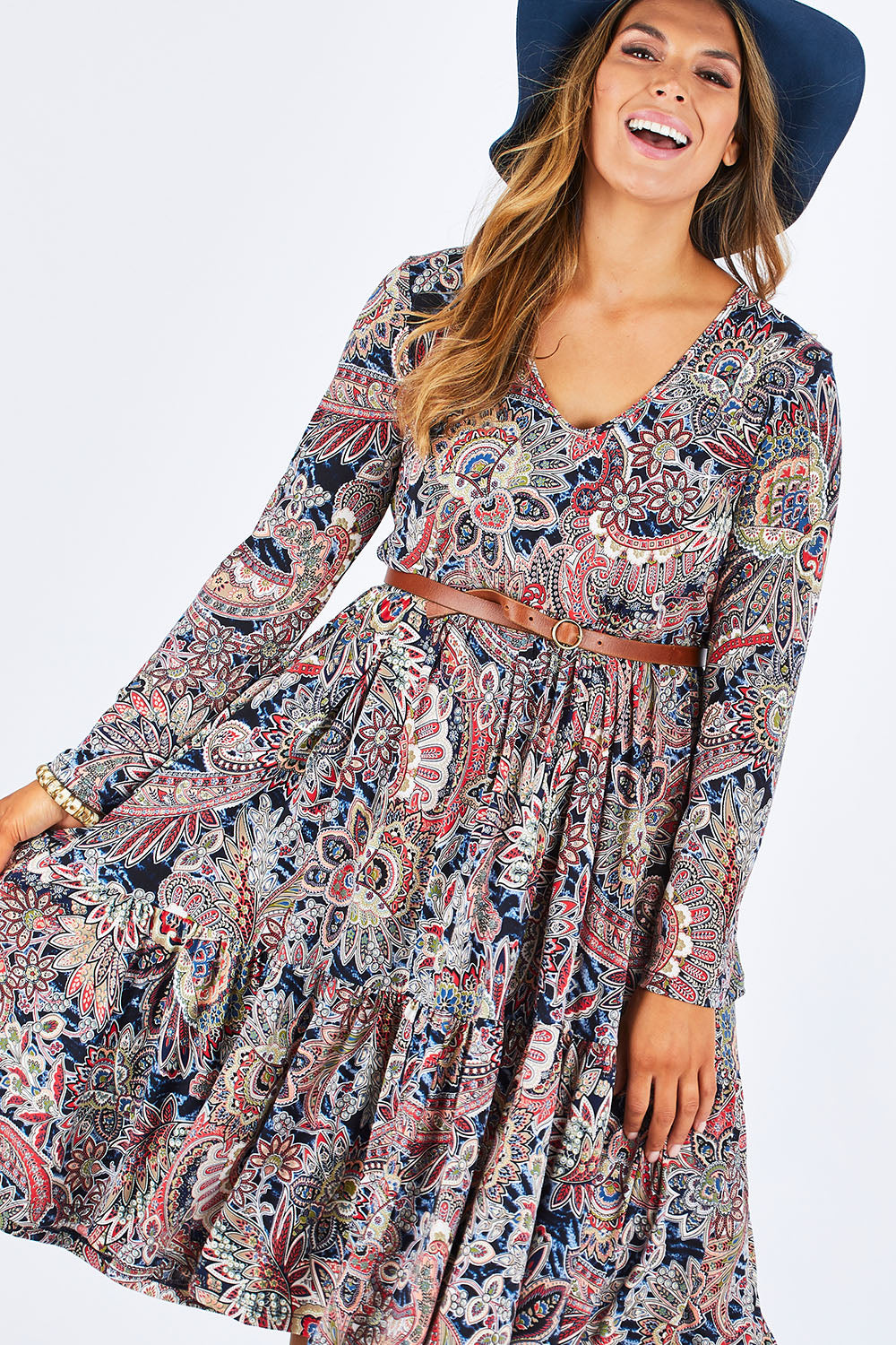 Model Palatina wearing size 14 of the Wind In My Hair Dress in colour Paisley (Red), from the front, cropped image