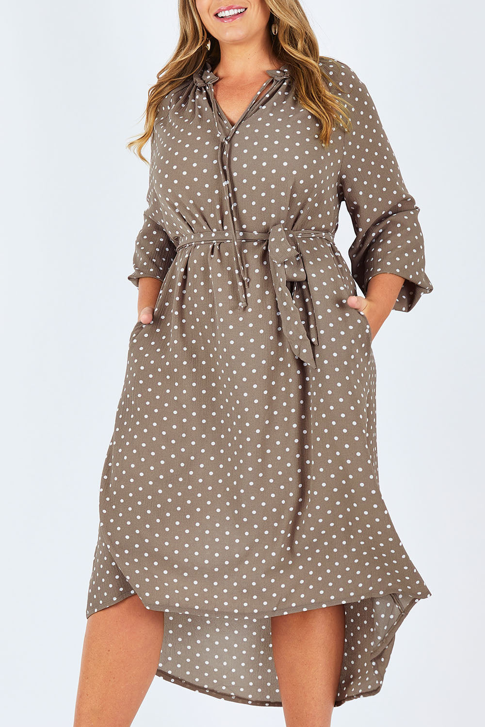 Model Fiona wearing size 16 of the Going With The Flow Dress in colour Taupe, from the front, cropped image