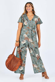 Model Palatina wearing size 14 of the Sunday Picnic Jumpsuit in colour Olivefleur (Green), from the front, showing the whole outfit