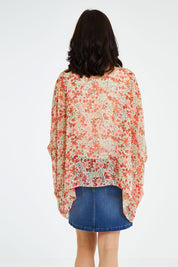 Model Andrea wearing size 10 of the Easy Peasy Throw Top in colour Orangepop, from the back