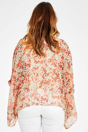 Model Laura wearing size 14 of the Easy Peasy Throw Top in colour Orangepop, from the back