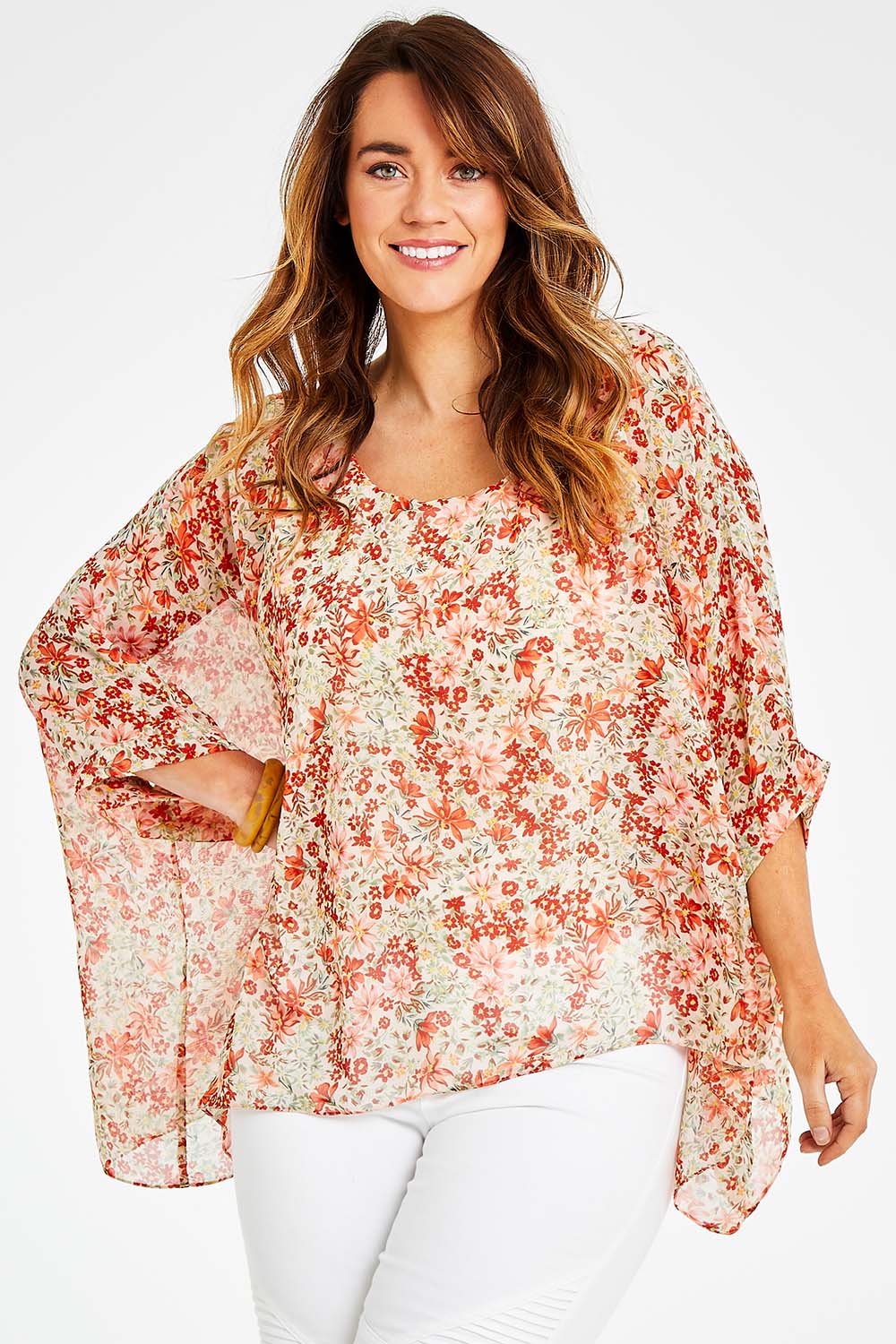 Model Laura wearing size 14 of the Easy Peasy Throw Top in colour Orangepop, from the front, cropped image