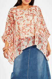 Model Sasha-Lee wearing size 14 of the Easy Peasy Throw Top in colour Orangepop, from the front, cropped image