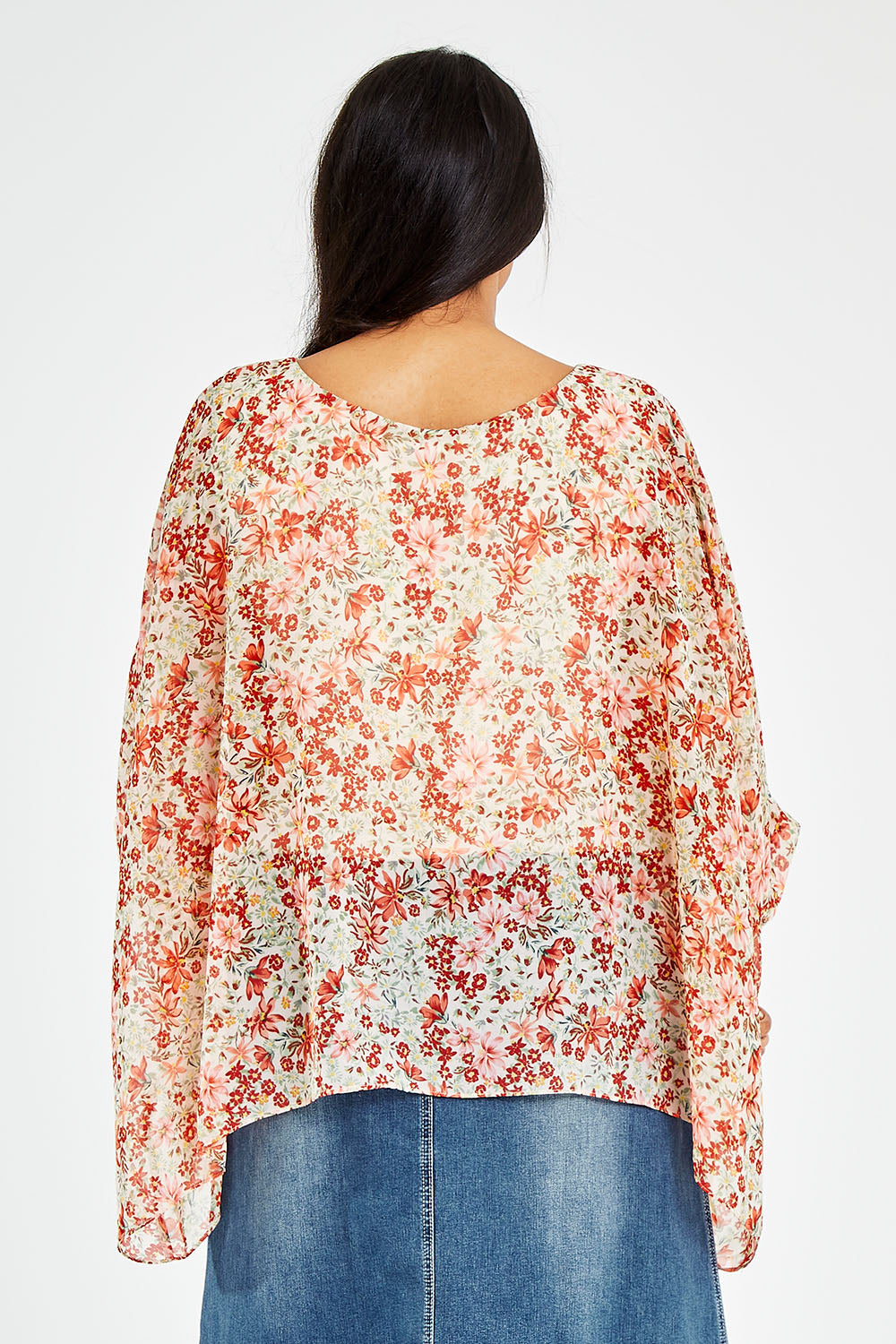 Model Sasha-Lee wearing size 16 of the Easy Peasy Throw Top in colour Orangepop, from the back