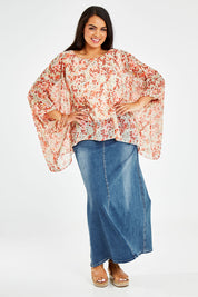Model Sasha-Lee wearing size 16 of the Easy Peasy Throw Top in colour Orangepop, from the front, showing the whole outfit