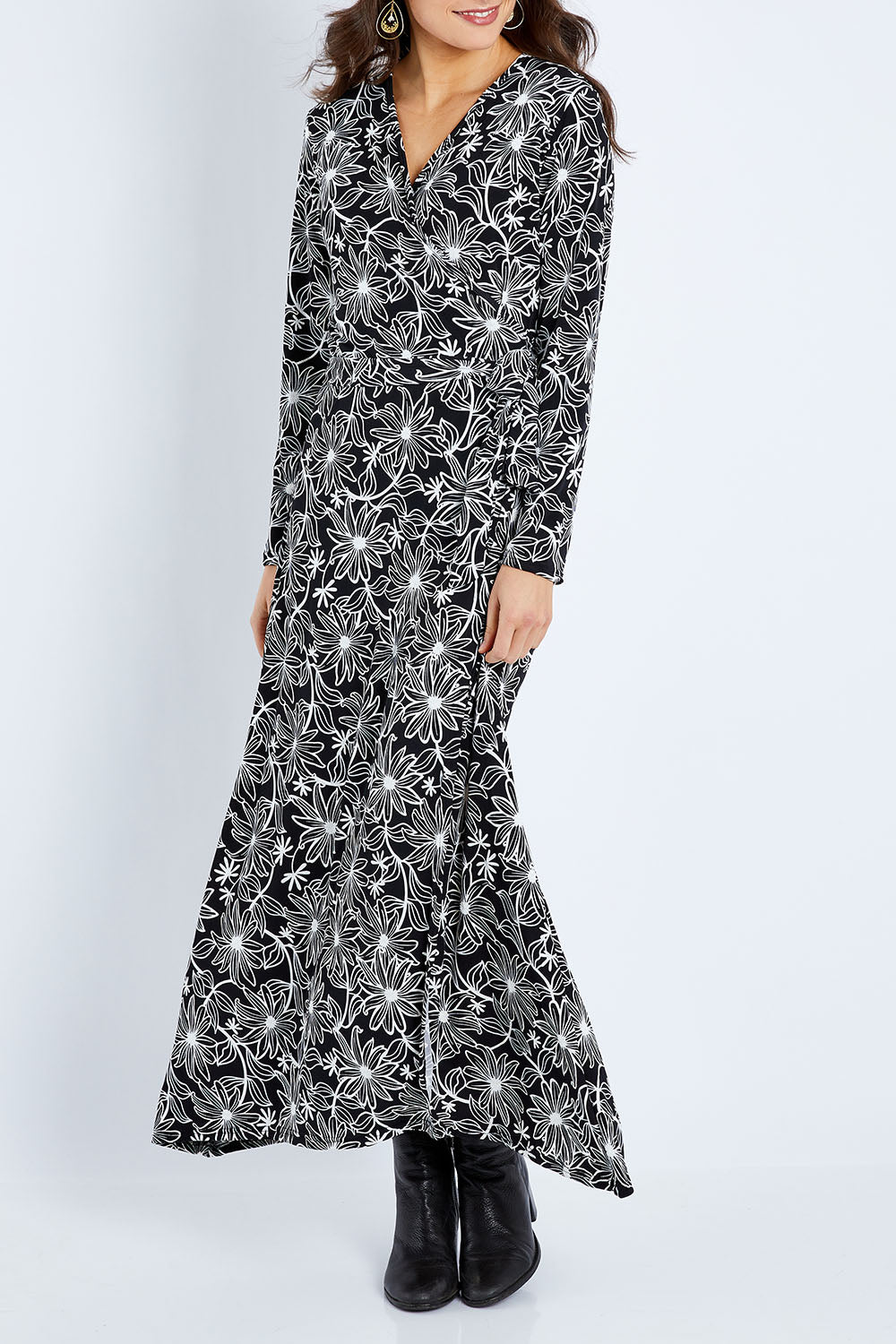 Model Elhana wearing size 10 of the Flowers In Winter Wrap Maxi Dress in colour Blkwhite (Black), from the front, cropped image