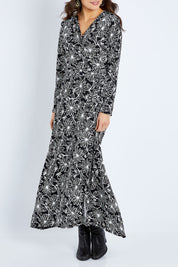 Model Elhana wearing size 10 of the Flowers In Winter Wrap Maxi Dress in colour Blkwhite (Black), from the front, cropped image