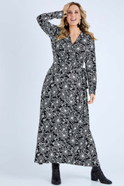 Model Jess wearing size 14 of the Flowers In Winter Wrap Maxi Dress in colour Blkwhite (Black), from the front, showing the whole outfit