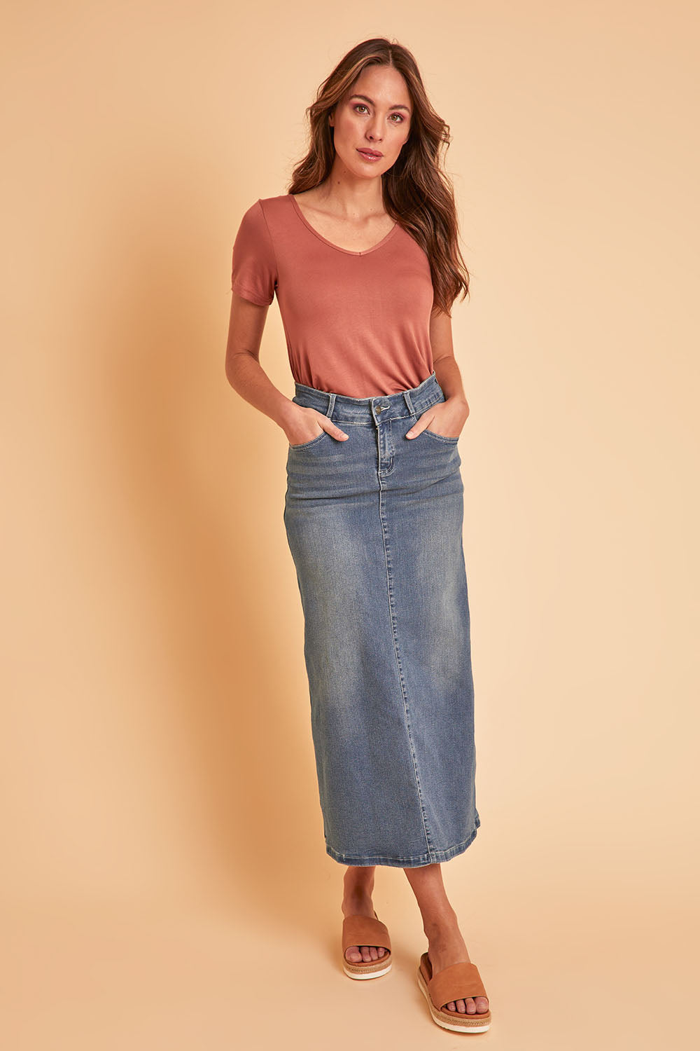 Model Madeline wearing size 10 of the Dusty Footprints Skirt in colour Denim (Blue), from the front, showing the whole outfit