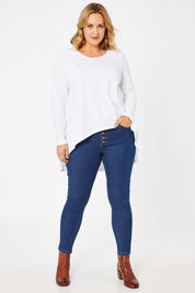 Model Jess wearing size 14 of the Follow Me Home Button Jeggings in colour Denim (Black), from the front, showing the whole outfit