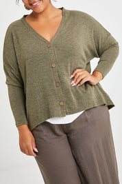 Model Alexis wearing size 16 of the My Boyfriends Slouch Cardi in colour Olive (Green), from the front, cropped image