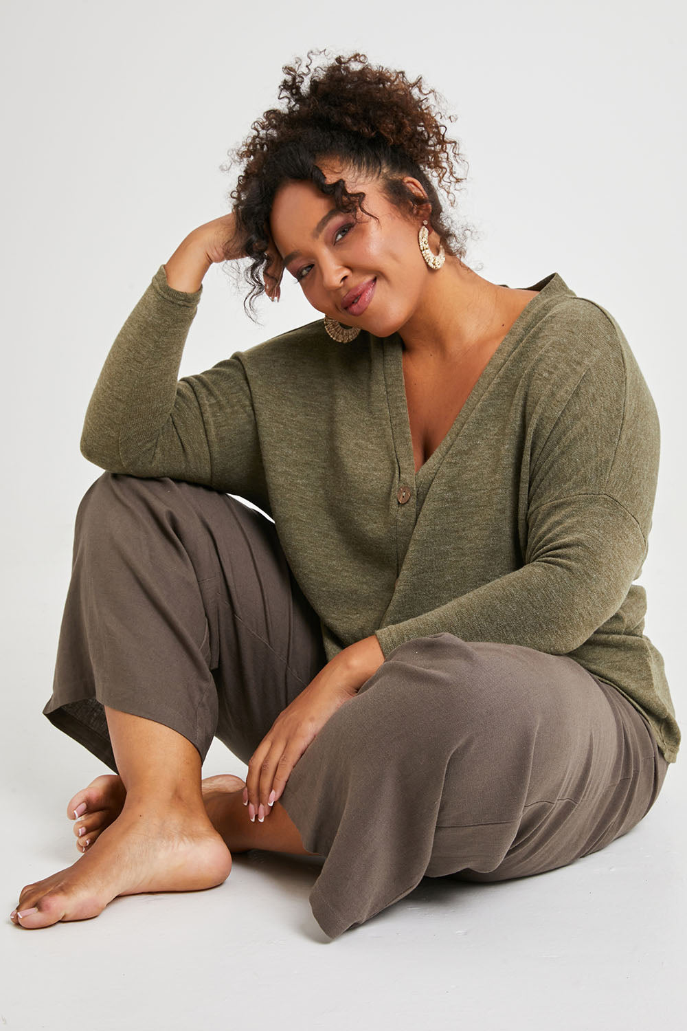 Model Alexis wearing size 16 of the My Boyfriends Slouch Cardi in colour Olive (Green), from the front, showing the whole outfit