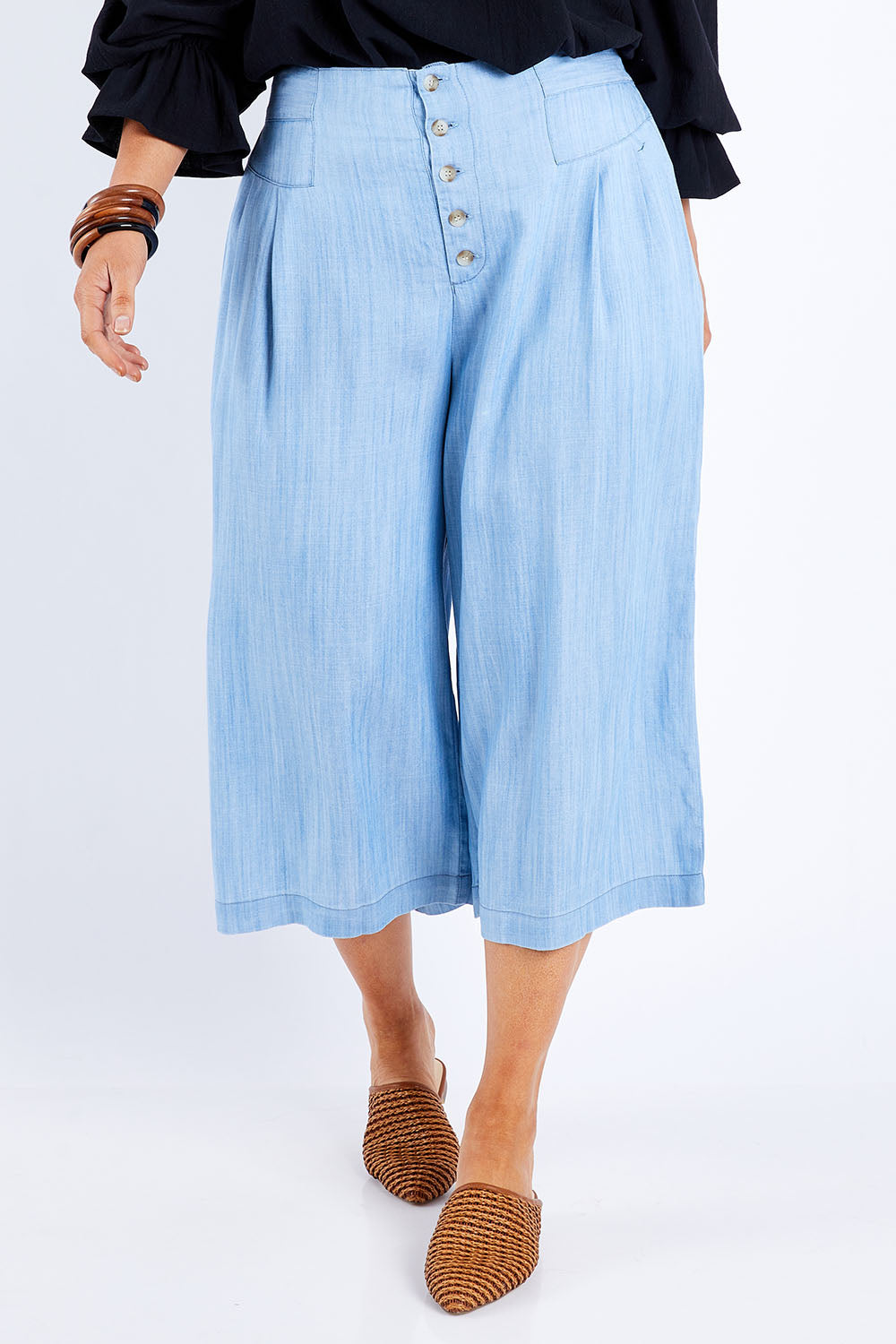 Model Laura wearing size 14 of the Delighted To Meet You Culottes in colour Chambray (Blue), from the front, cropped image