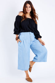 Model Laura wearing size 14 of the Delighted To Meet You Culottes in colour Chambray (Blue), from the front, showing the whole outfit