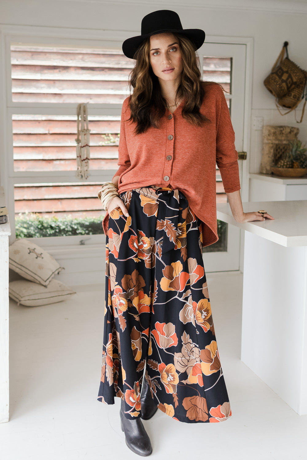 Model Ilona wearing size 10 of the Walk This Way Wide Leg Pants in colour Blackrust (Black), from the front, showing the whole outfit