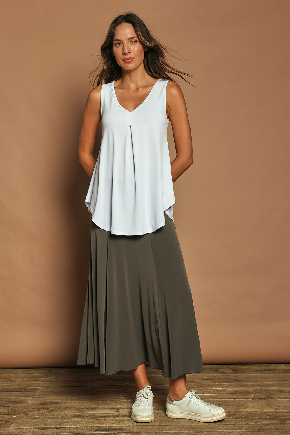Model Madeline wearing size 10 of The Wanderer In Me V Neck Travel Singlet in colour White (White), from the front, showing the whole outfit