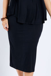 Model Laura wearing size 14 of the Softly Swinging Bamboo Tube Skirt in colour Black (Black), from the front, cropped image