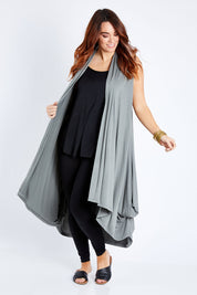 Model Laura wearing size 12 of the Softly Swinging Bamboo Vest in colour Fern (Green), from the front, showing the whole outfit