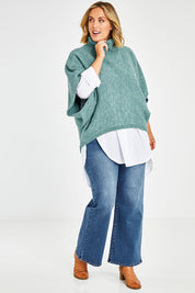 Model Jess wearing size L of the Addicted To You Sweater in colour Sea (Blue), from the front, showing the whole outfit