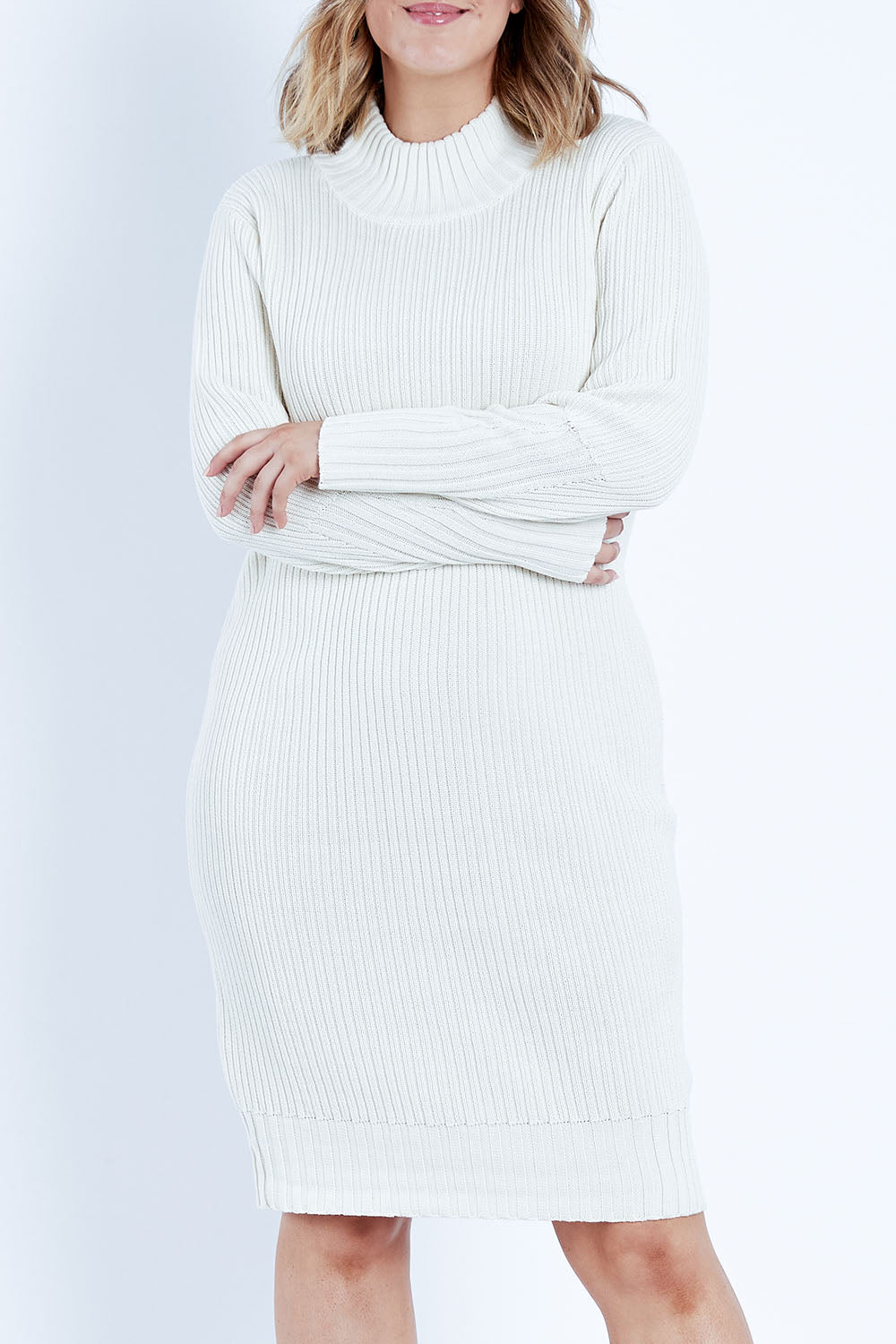 Model Jess wearing size L of the With My Crew Sweater Dress in colour Snow (White), from the front, cropped image