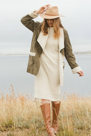 Model Katie wearing size S of the With My Crew Sweater Dress in colour Snow (White), from the front, showing the whole outfit
