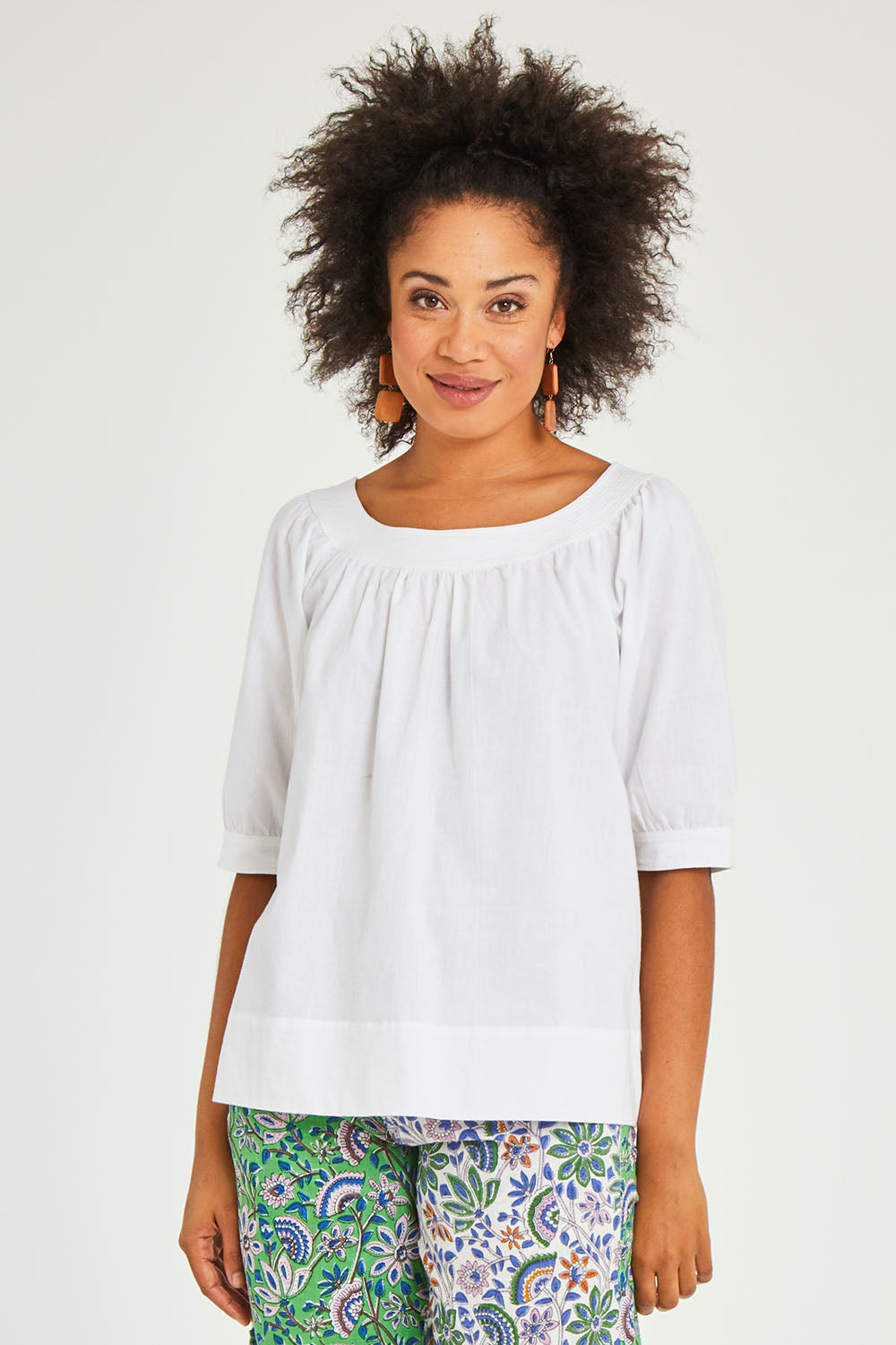 Model Olivia wearing size 10 of the Bliss Top in colour White (White), from the front, cropped image