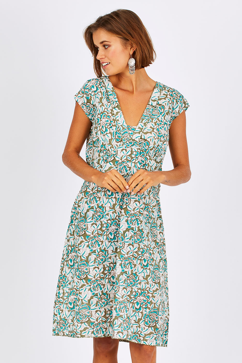 Model Nikki wearing size 10 of the Daisy Dress in colour Aqua (Blue), from the front, cropped image