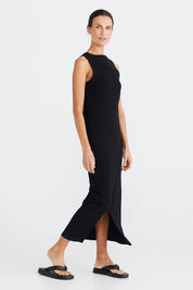 A model wearing the Carrie Dress in colour Black (Black), from the front, showing the whole outfit