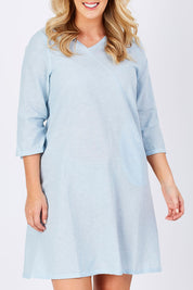 Model Jess wearing size M of the Gela Dress in colour Sky (Blue), from the front, cropped image