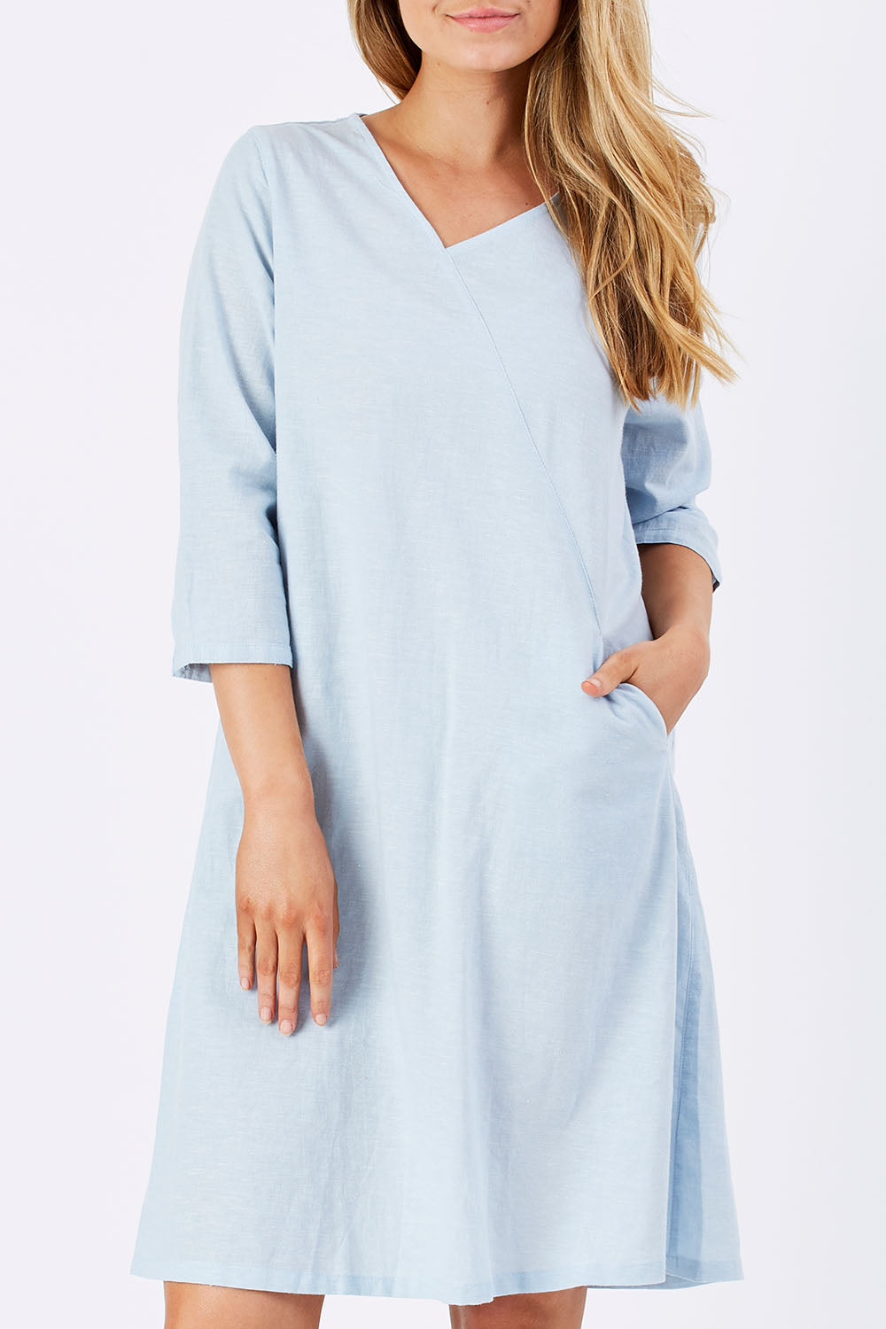 Model Marnee wearing size S of the Gela Dress in colour Sky (Blue), from the front, cropped image