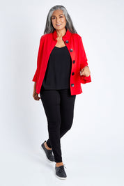 Model Nadine wearing size S of the Crimson Button Jacket in colour Red (Red), from the front, showing the whole outfit