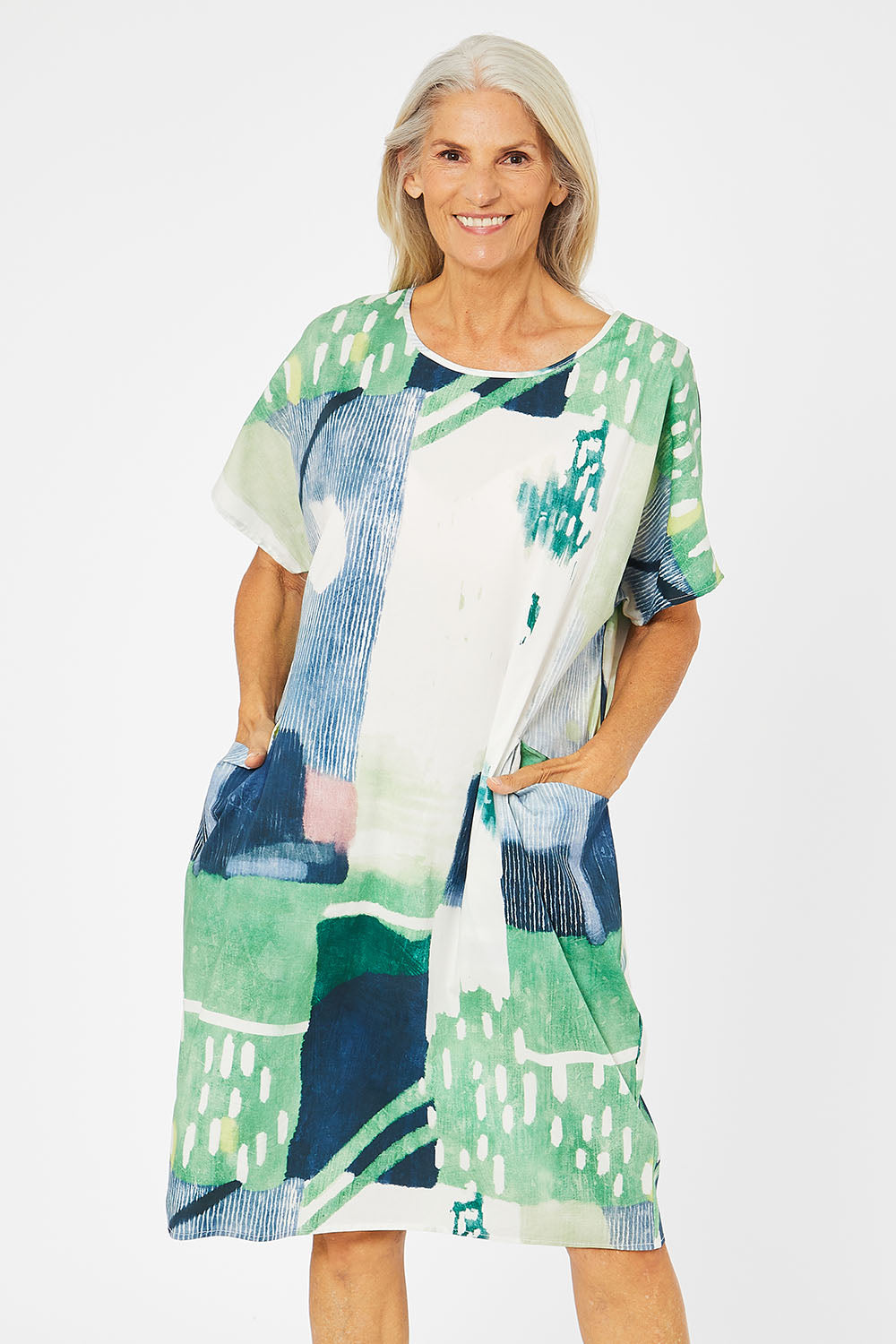 Model Rachel wearing size S of the Pocket Print Dress in colour Multi (Green), from the front, cropped image