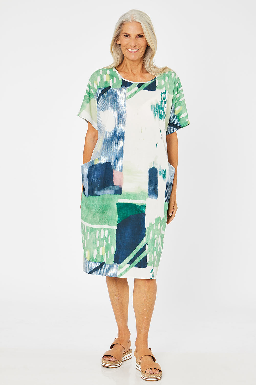 Model Rachel wearing size S of the Pocket Print Dress in colour Multi (Green), from the front, showing the whole outfit