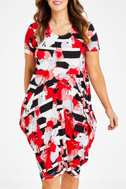 Model Laura wearing size 14 of the Cap Sleeve Bounce Dress in colour Red (Red), from the front, cropped image