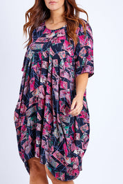 Model Laura wearing size 14 of the Rayon Bounce Dress in colour Print (Pink), from the front, cropped image