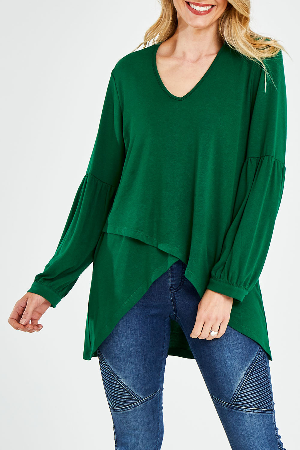 Model Kelly wearing size 10 of the Hi Lo Knit Tunic in colour Emerald (Green), from the front, cropped image