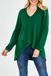 Model Kelly wearing size 10 of the Hi Lo Knit Tunic in colour Emerald (Green), from the front, cropped image