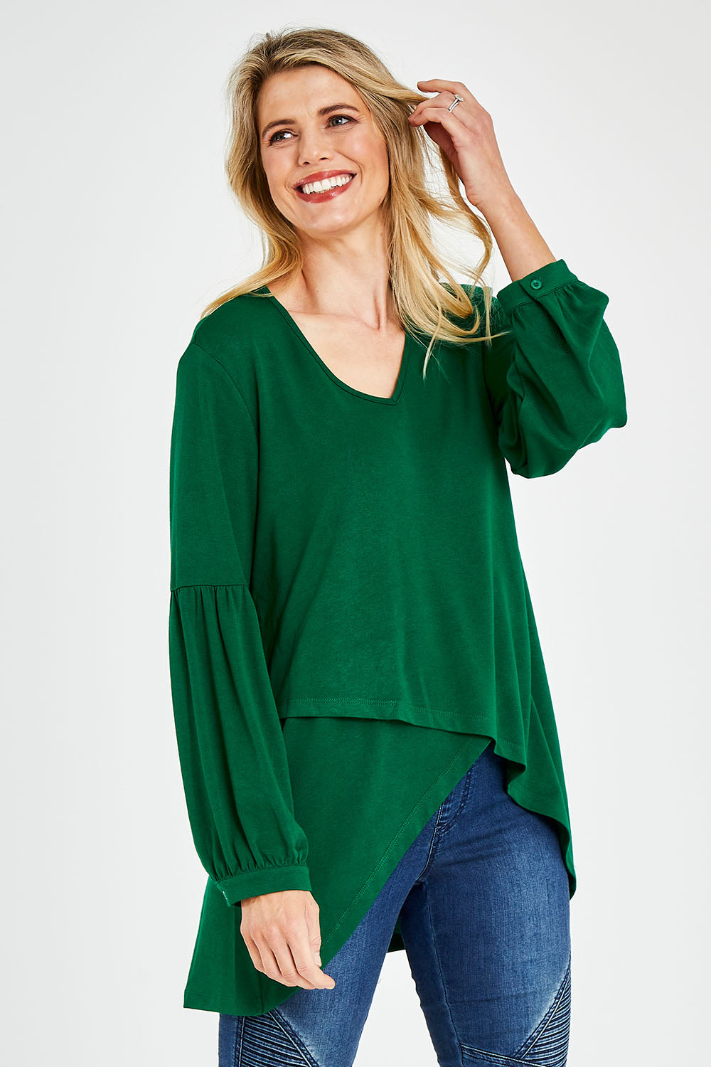 Model Kelly wearing size 10 of the Hi Lo Knit Tunic in colour Emerald (Green), from the front, cropped image