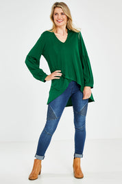 Model Kelly wearing size 10 of the Hi Lo Knit Tunic in colour Emerald (Green), from the front, showing the whole outfit