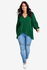 Model Laura wearing size 14 of the Preloved Hi Lo Knit Tunic in colour Emerald (Green), from the front, showing the whole outfit