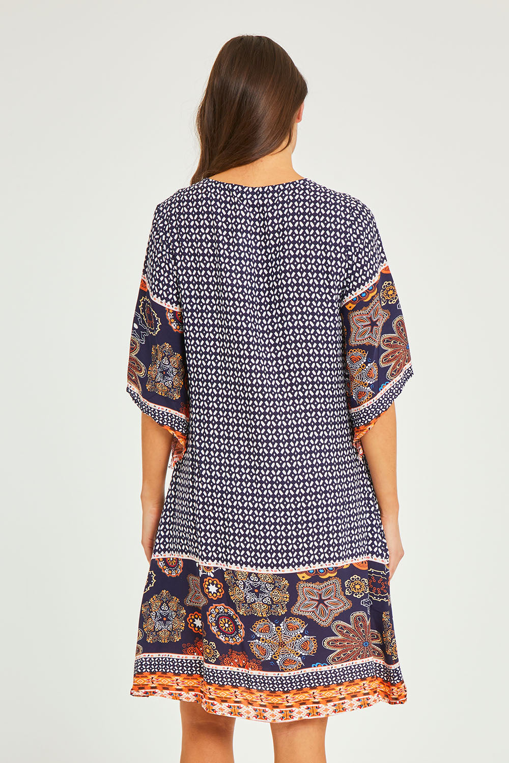 Model Elhana wearing size 10 of the Sun Dress in colour Navyprint (Blue), from the back