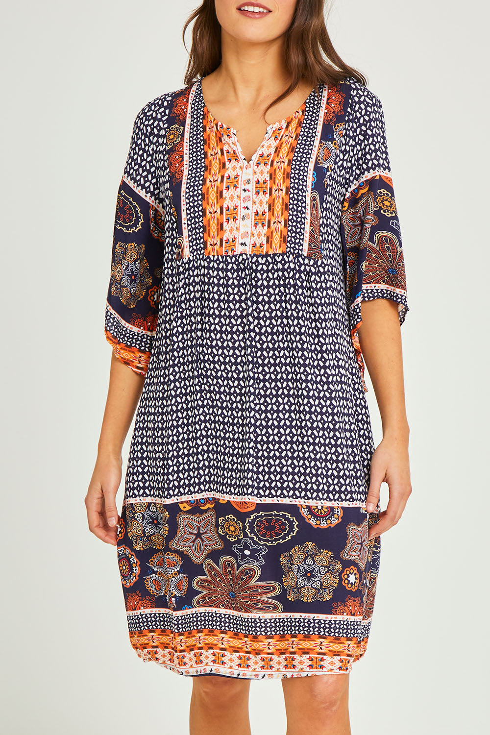 Model Elhana wearing size 10 of the Sun Dress in colour Navyprint (Blue), from the front, cropped image