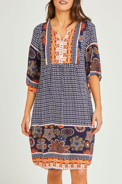 Model Elhana wearing size 10 of the Sun Dress in colour Navyprint (Blue), from the front, cropped image